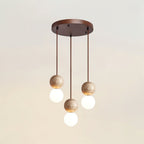 Five cords cascade travertine and glass spheres at staggered heights from this Clérachic pendant's round canopy.