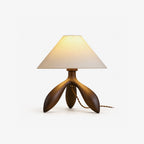 Studio shot of this Clérachic lamp in dark wood, its curved tripod base and cone shade shown unlit.