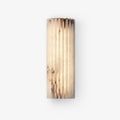 Alabaster wall light glowing softly in a styled interior