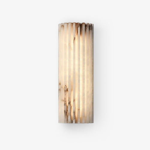 Alabaster wall light glowing softly in a styled interior