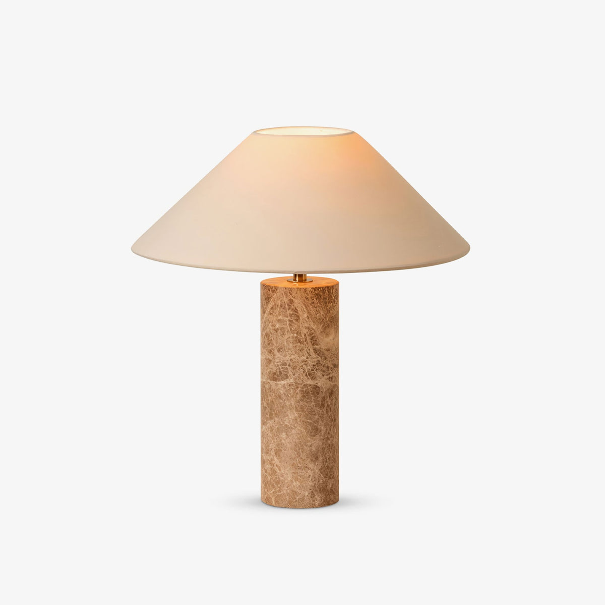 The Clérachic table lamp shown alone on a plain grey background, its beige fabric shade lit warmly above the marble column.