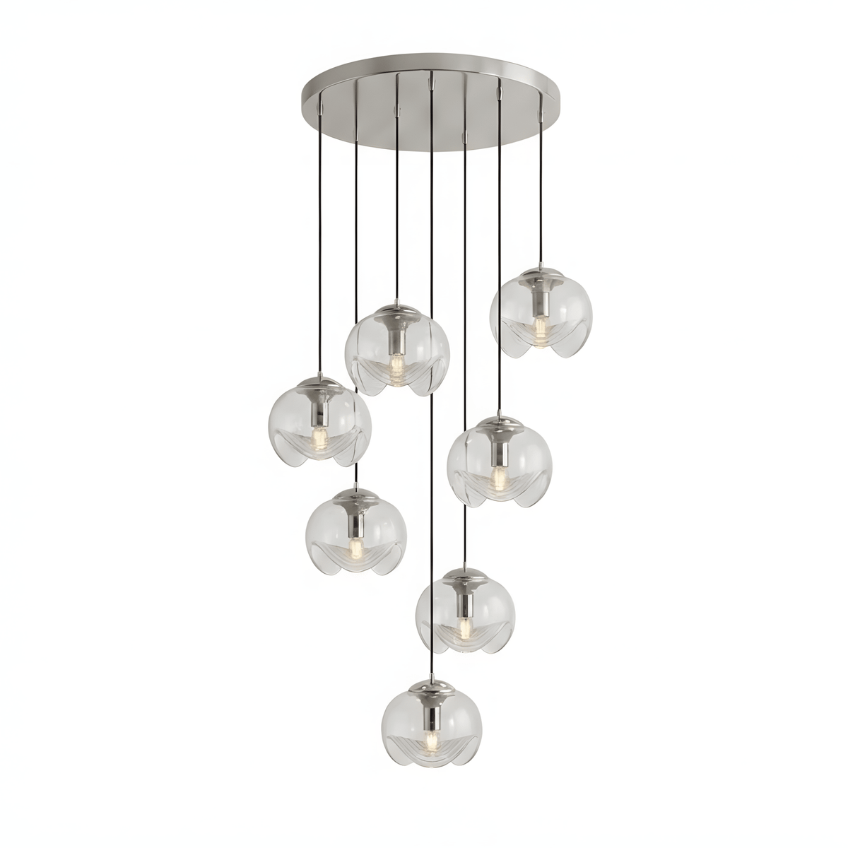 Round clear glass shades hang at varied heights from a silver ceiling plate, this Clérachic fixture shown on a white background.