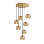 Round amber glass shades cascade in a loose spiral from a gold ceiling plate, this Clérachic fixture shown on a white background.
