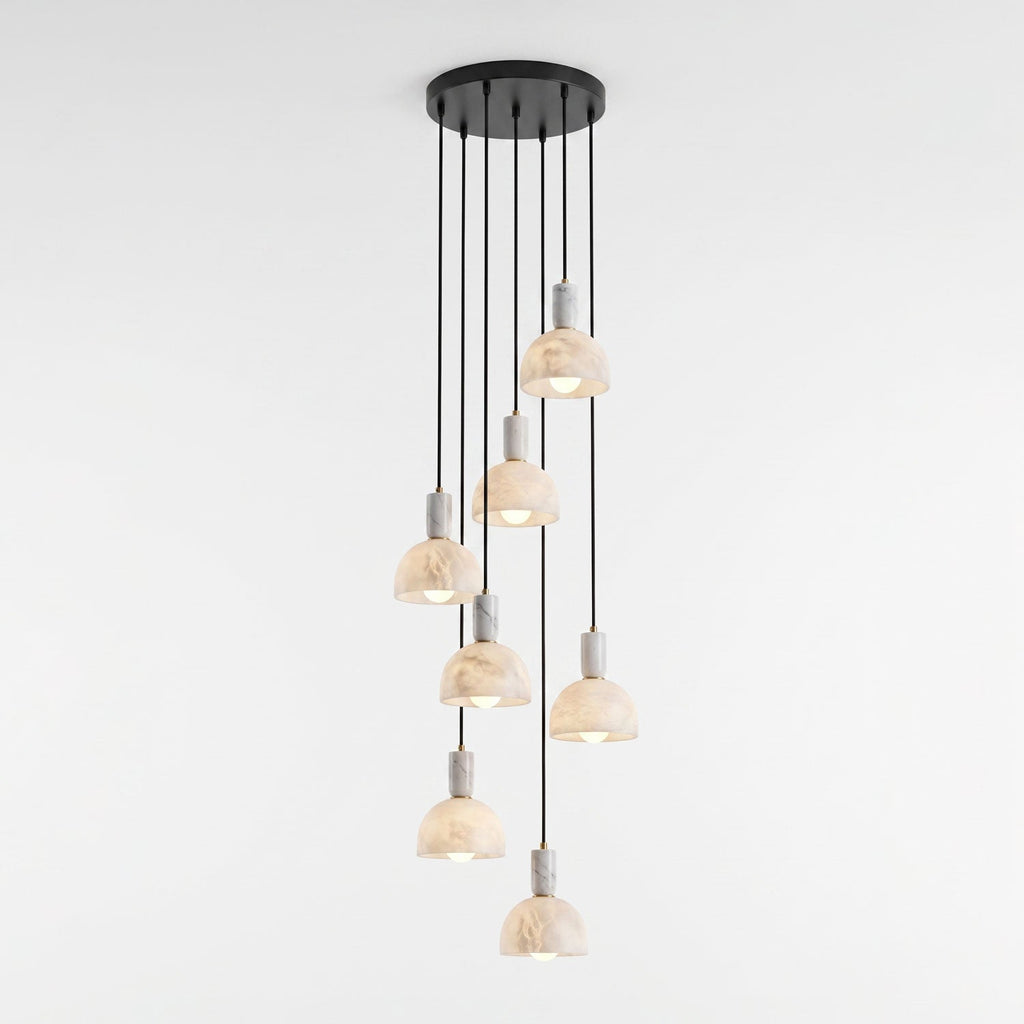 A cluster of alabaster domes hangs unlit at staggered heights from a round black plate, spiralling down on this Clérachic pendant.