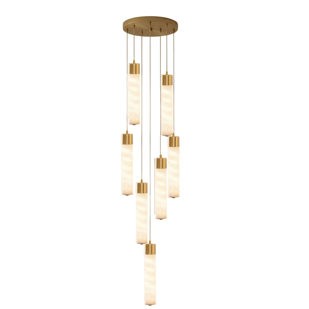 A cluster of seven brass-capped alabaster tubes cascades from this Clérachic pendant's round ceiling plate on white.