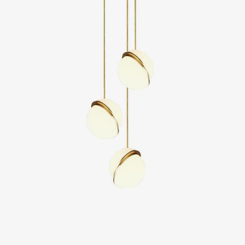 On an off-white backdrop, three of this Clérachic pendant hang in a cascading row.