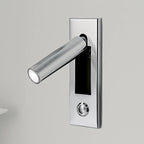 Close detail of the folding arm on a recessed bedside wall sconce