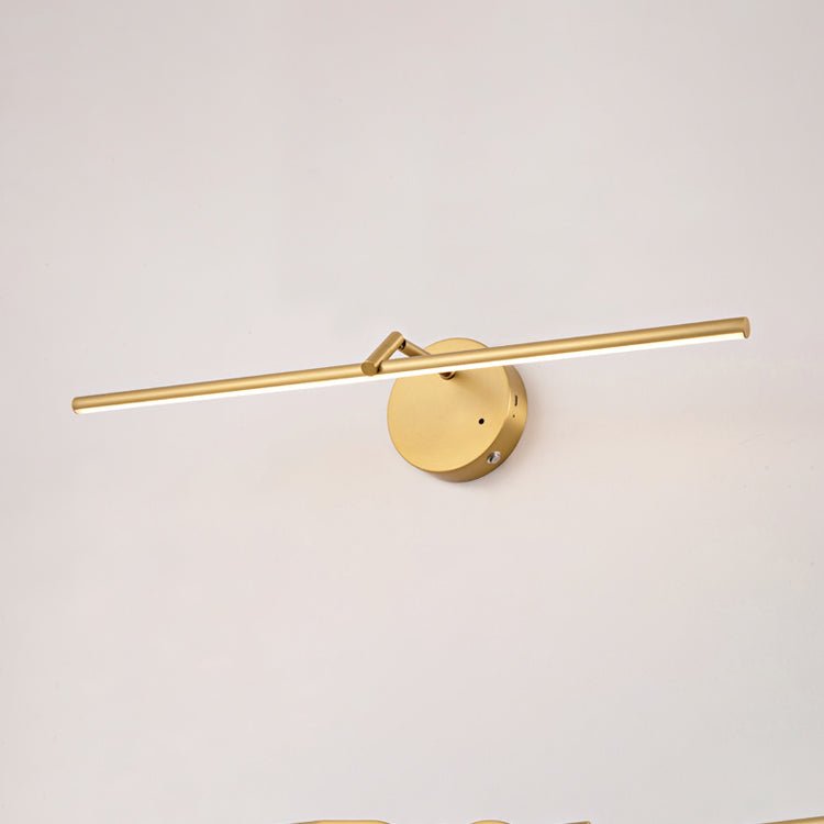 Front view of this gold-finish Clérachic wall light on a plain wall, the slim bar centred through its round canopy, unlit.