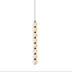 Eight-ball version of the Orbique pendant, alabaster spheres stacked along a black metal stem