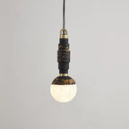 Black-and-gold marble pendant switched on, light glowing through the lower half of the alabaster globe.