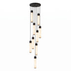 A dense cluster of black-capped alabaster tubes cascades from this Clérachic pendant's round ceiling plate on white.