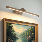 Gold picture light casting an even wash across a painting