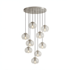 Clear glass shades cascade densely from a silver ceiling plate, this Clérachic fixture shown in a tall cluster on white.