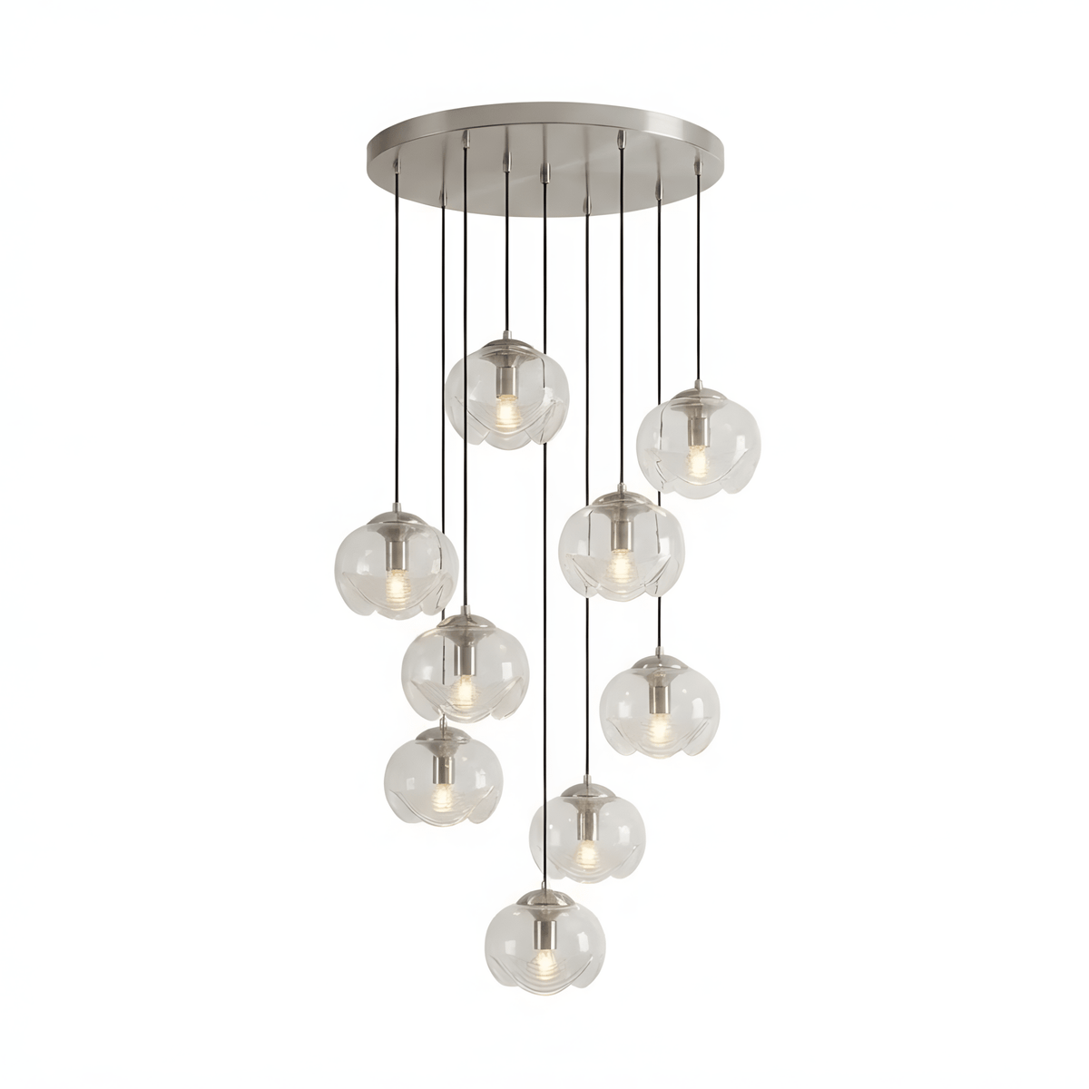 Clear glass shades cascade densely from a silver ceiling plate, this Clérachic fixture shown in a tall cluster on white.