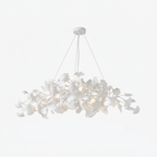 Cloud of porcelain ginkgo leaves lit warmly from within