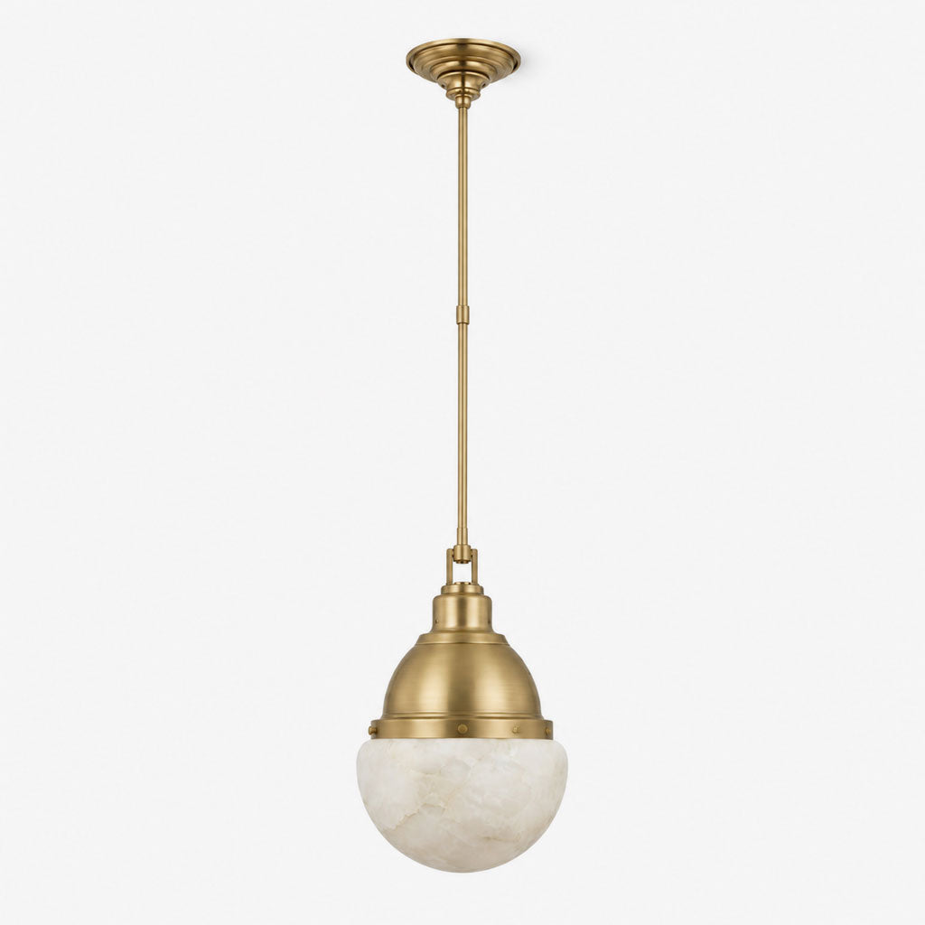 Studio shot of this Clérachic pendant in brushed brass, with its alabaster ball shade and slender stem.
