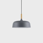 Acorn pendant light glowing softly in a warm interior
