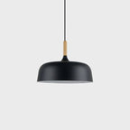 Acorn pendant light hanging above a styled dining table