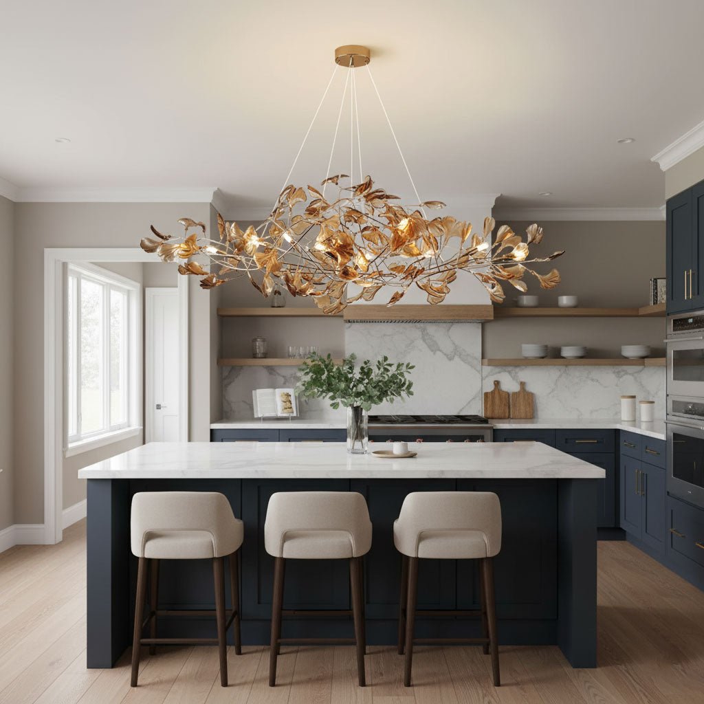 Ginkgo leaf chandelier glowing over a kitchen island counter