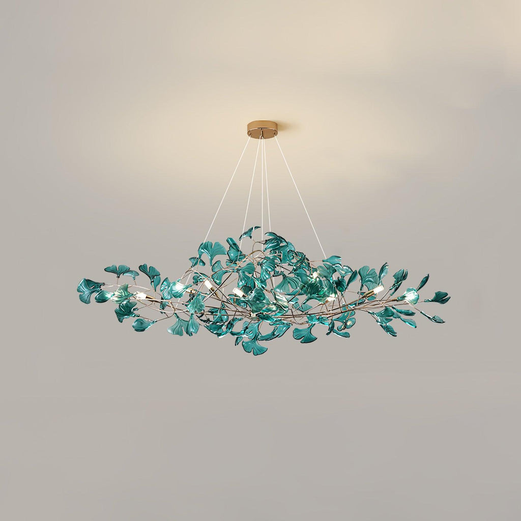 Ginkgo leaf chandelier glowing above a foyer entryway