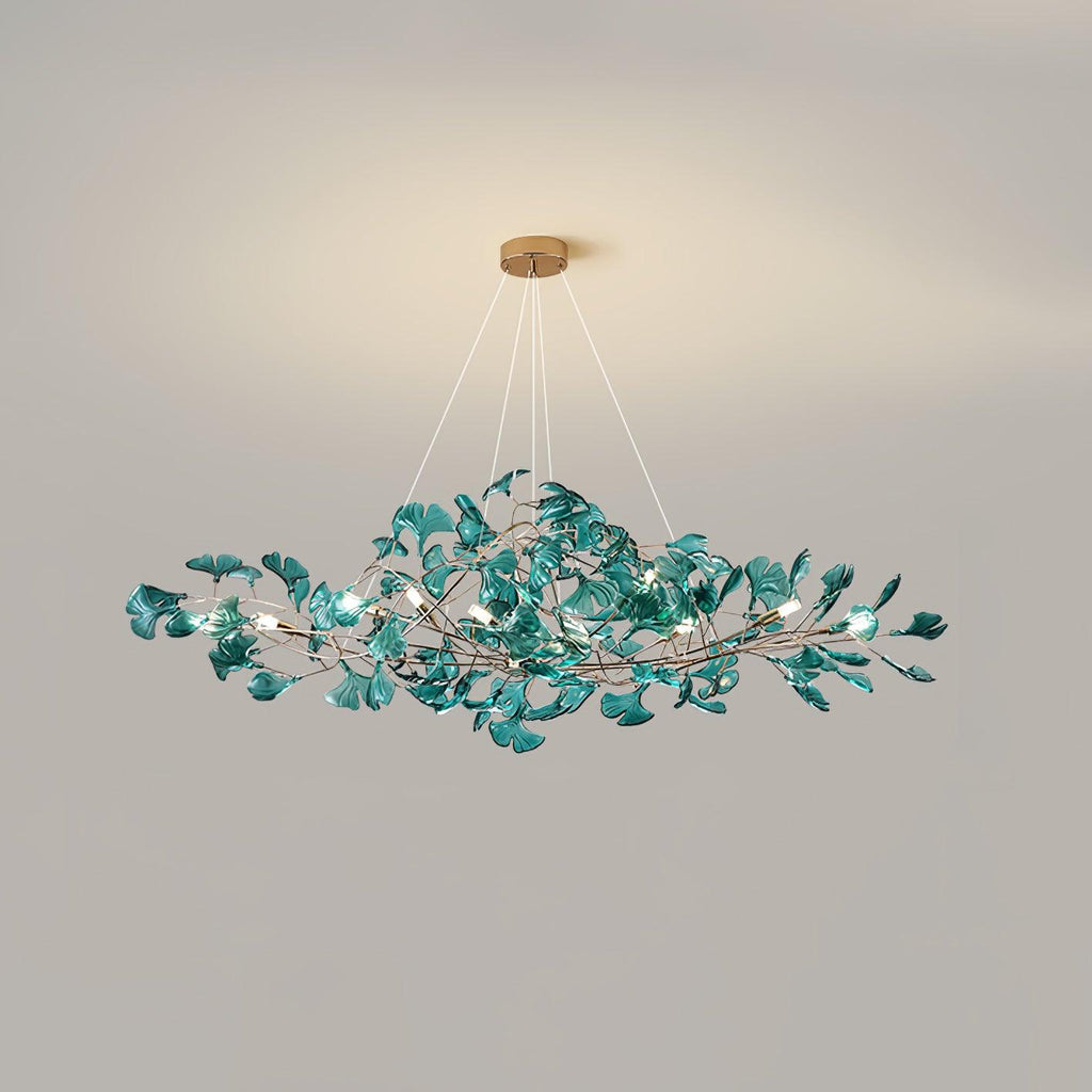 Ginkgo leaf chandelier lit warmly over a styled table