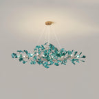 Ginkgo leaf chandelier lit warmly over a styled table