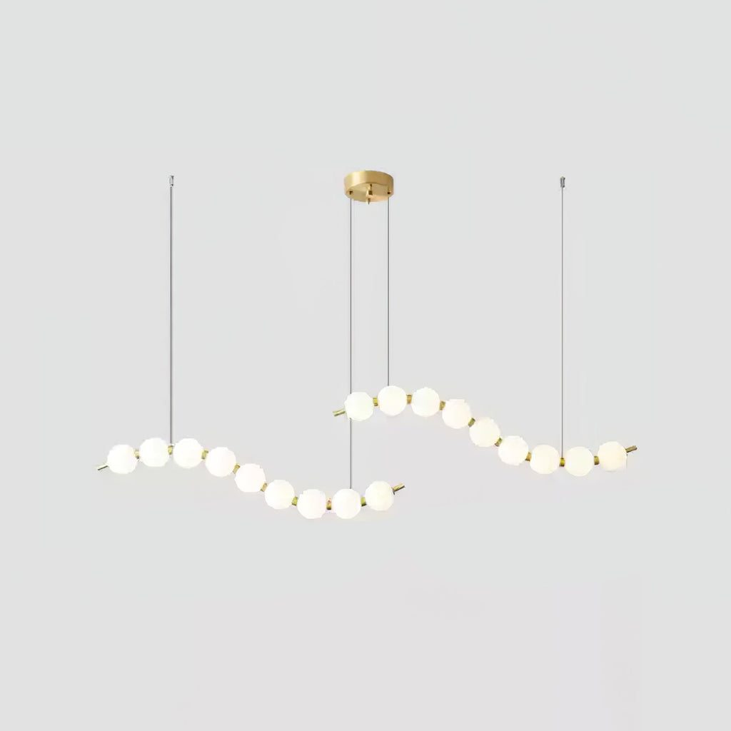 Acrylic pearl chandelier close view of orbs and brass frame
