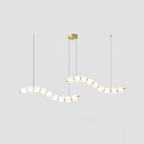Acrylic pearl chandelier close view of orbs and brass frame