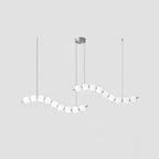 Acrylic pearl chandelier with clustered white orbs glowing warmly