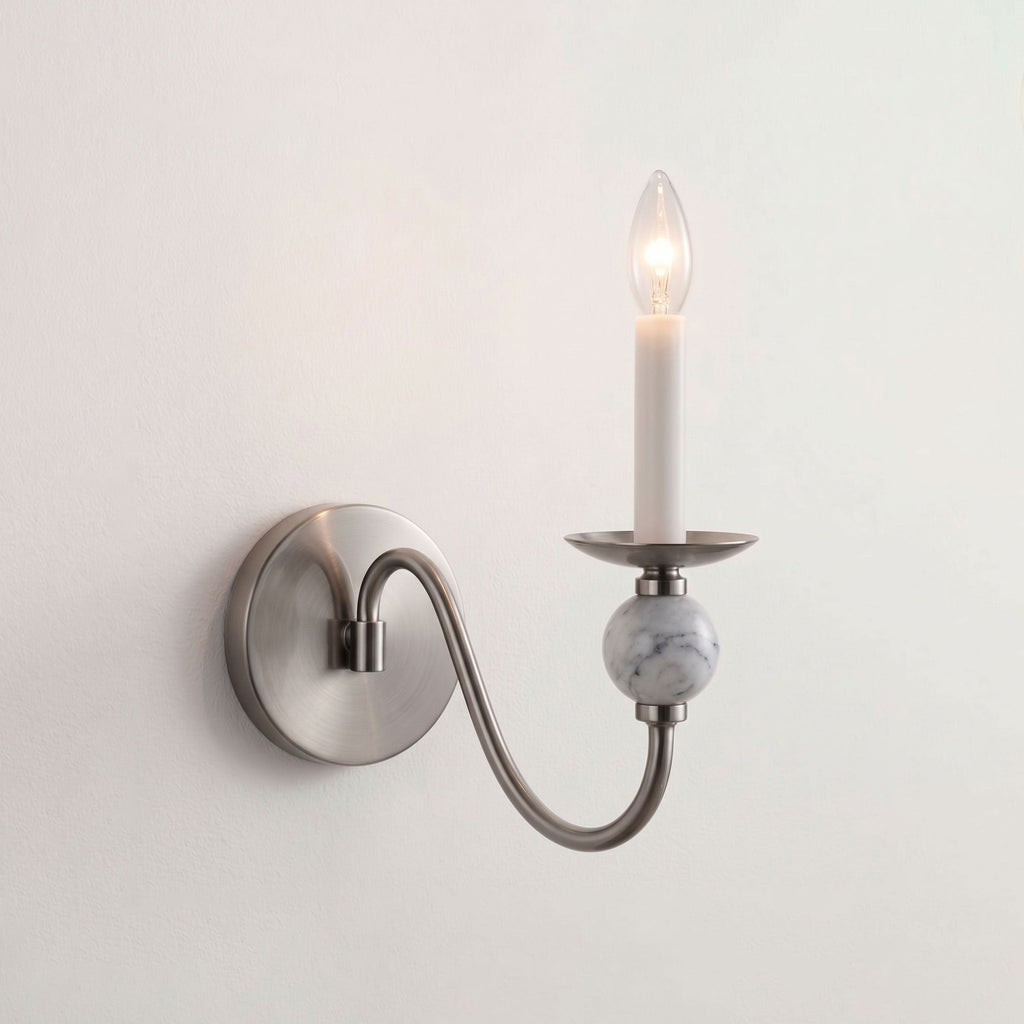 Isolated on white, this Clérachic wall light shows a brushed-nickel arm curving down to a marble ball.