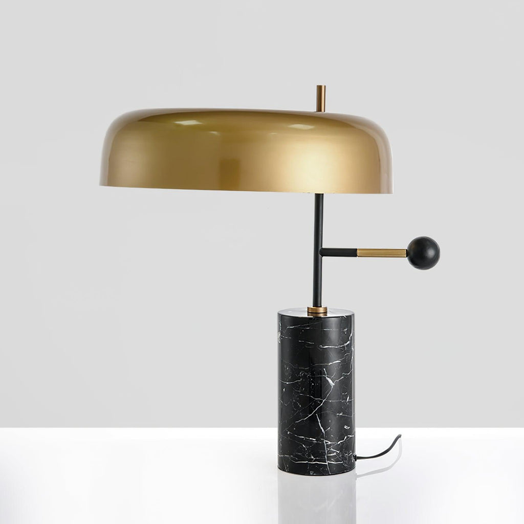 This angle catches a bright reflection across the Clérachic lamp's glossy gold dome shade on a white background.