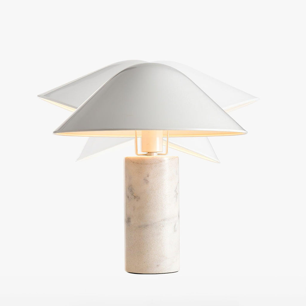Low-angle view of the white shade's pointed underside on a Clérachic table lamp, backlit against the marble column.