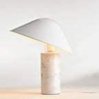 Warm cream studio light surrounds this Clérachic white marble table lamp, its shade's underside glowing softly.