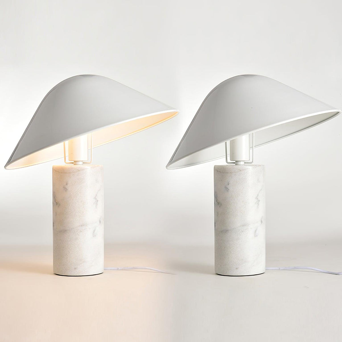 Two identical Clérachic white marble table lamps lit side by side on a white studio background, cords visible at the base.