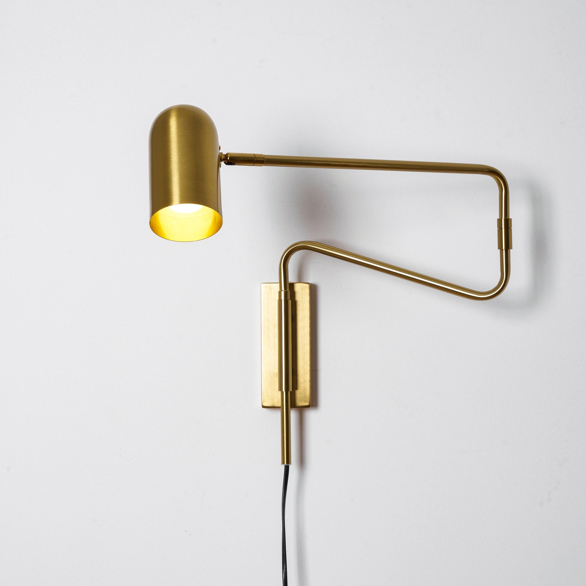 Swing arm wall lamp compact model on a neutral wall