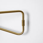 Swing arm wall lamp gold finish above a reading nook