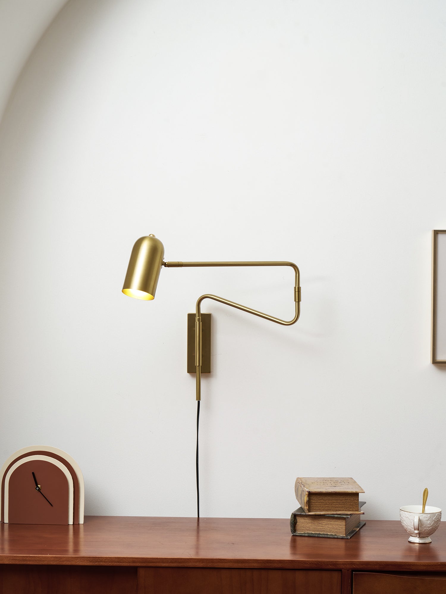 Swing arm wall lamp shown with the arm fully extended