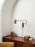 Swing arm wall lamp black model in a modern bedroom