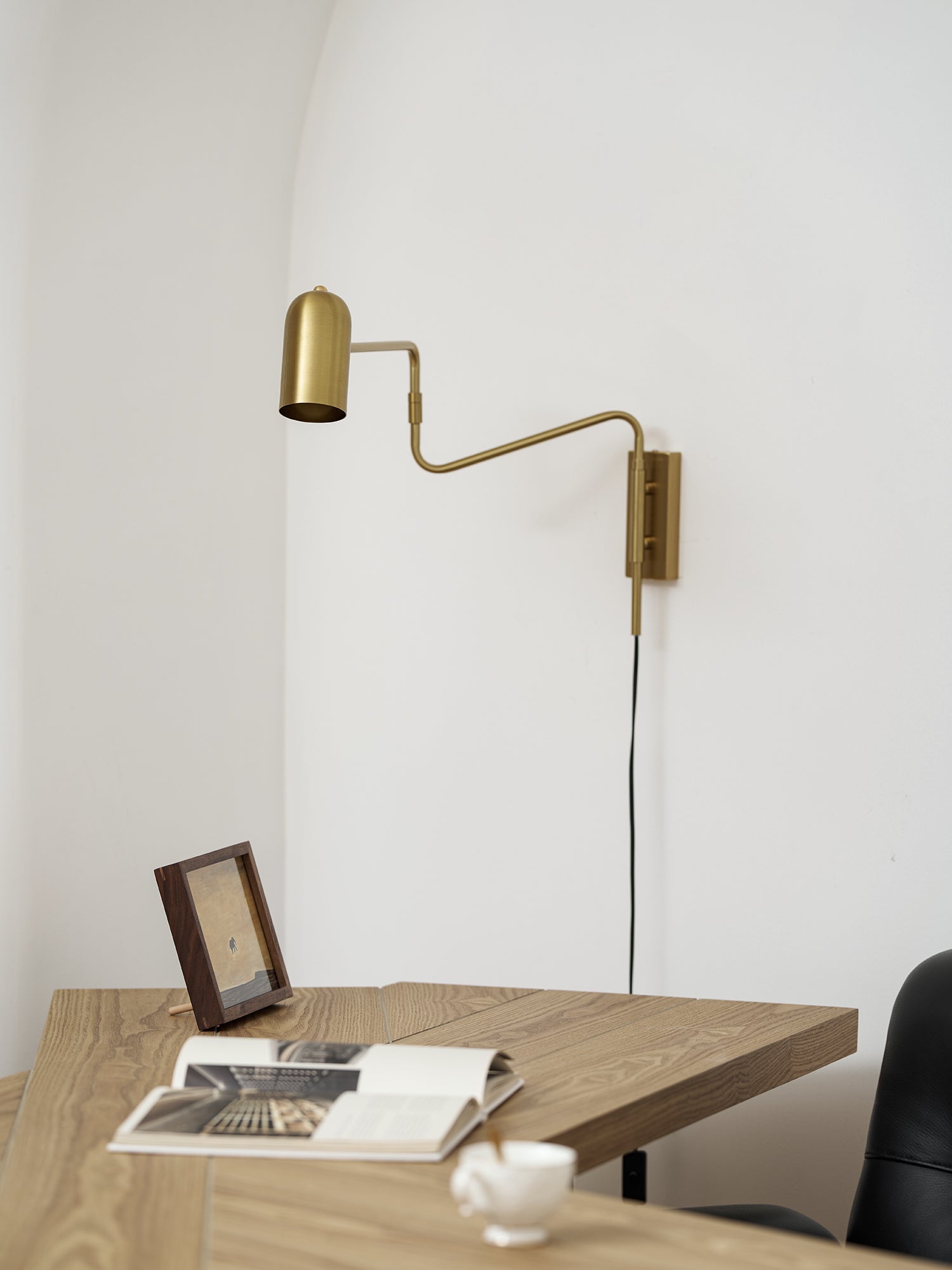 Swing arm wall lamp black finish in a styled interior