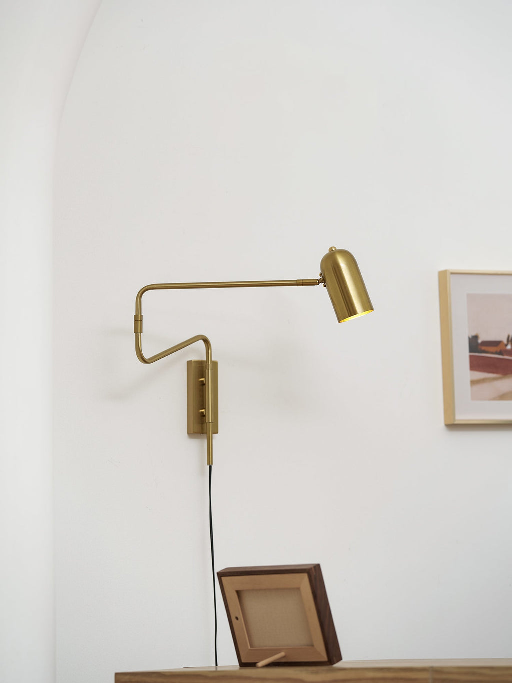 Swing arm wall lamp detail of shade and metal arm