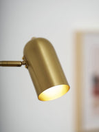 Swing arm wall lamp shown mounted in a styled bedroom