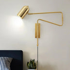 Swing arm wall lamp with the arm angled for reading