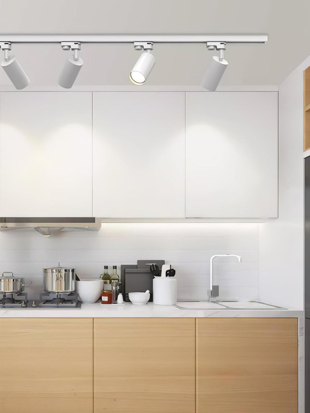 Track ceiling light with white heads against a pale ceiling
