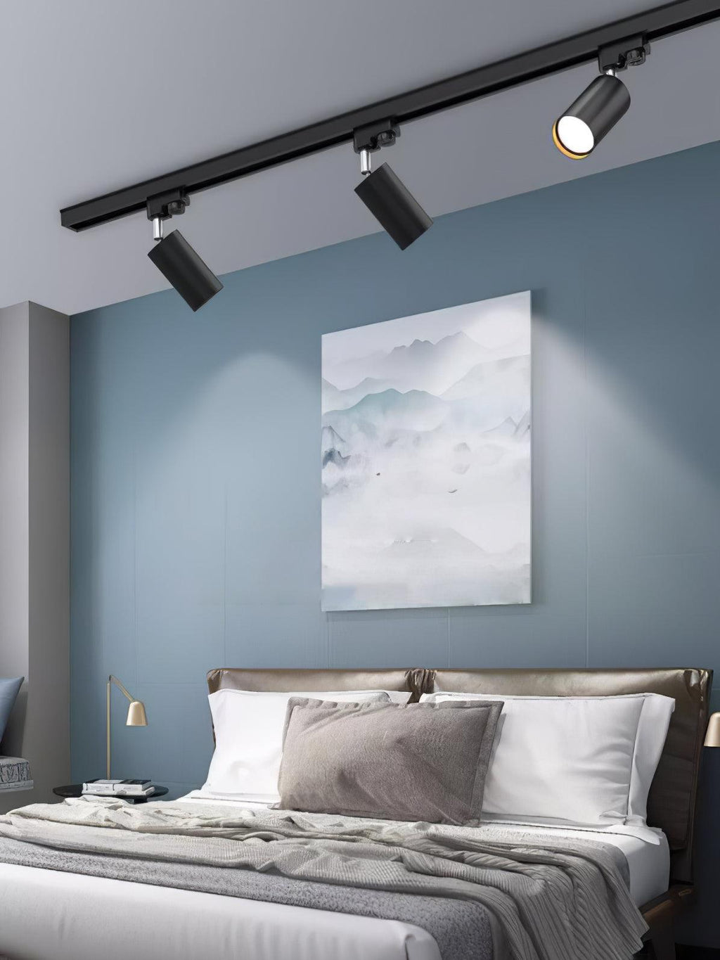 Track ceiling light spotlights angled across a textured wall
