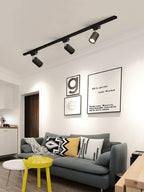 Track ceiling light spotlights illuminating an office workspace