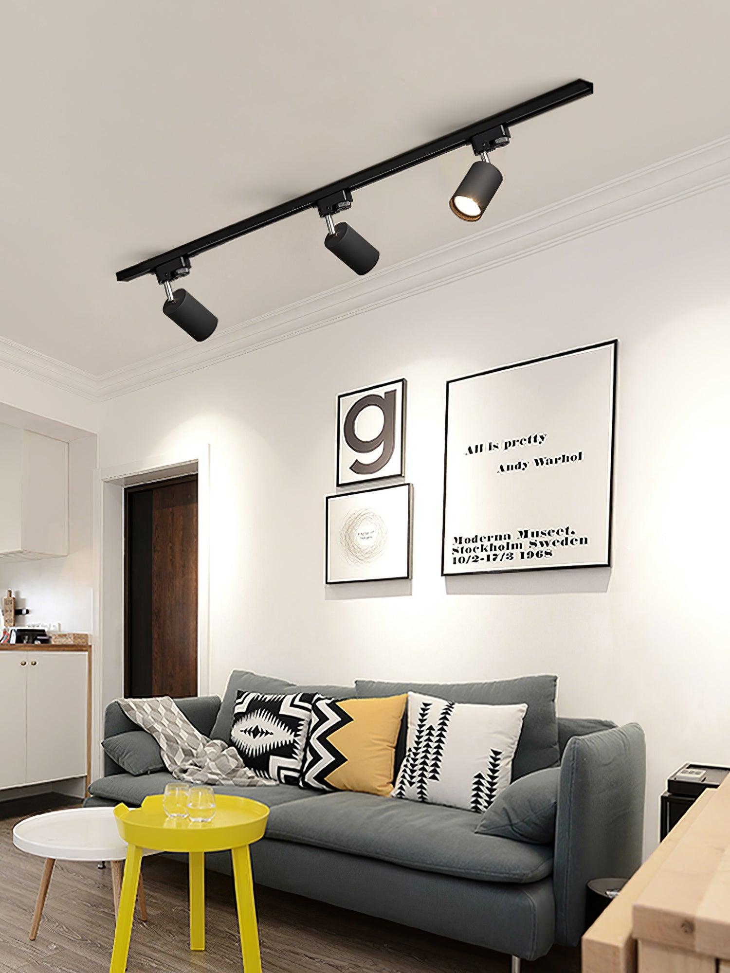 Track ceiling light spotlights illuminating an office workspace