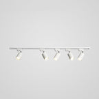 Track ceiling light spotlights highlighting a kitchen counter