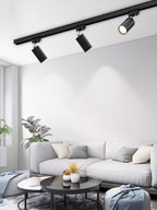 Track ceiling light shown casting focused accent beams