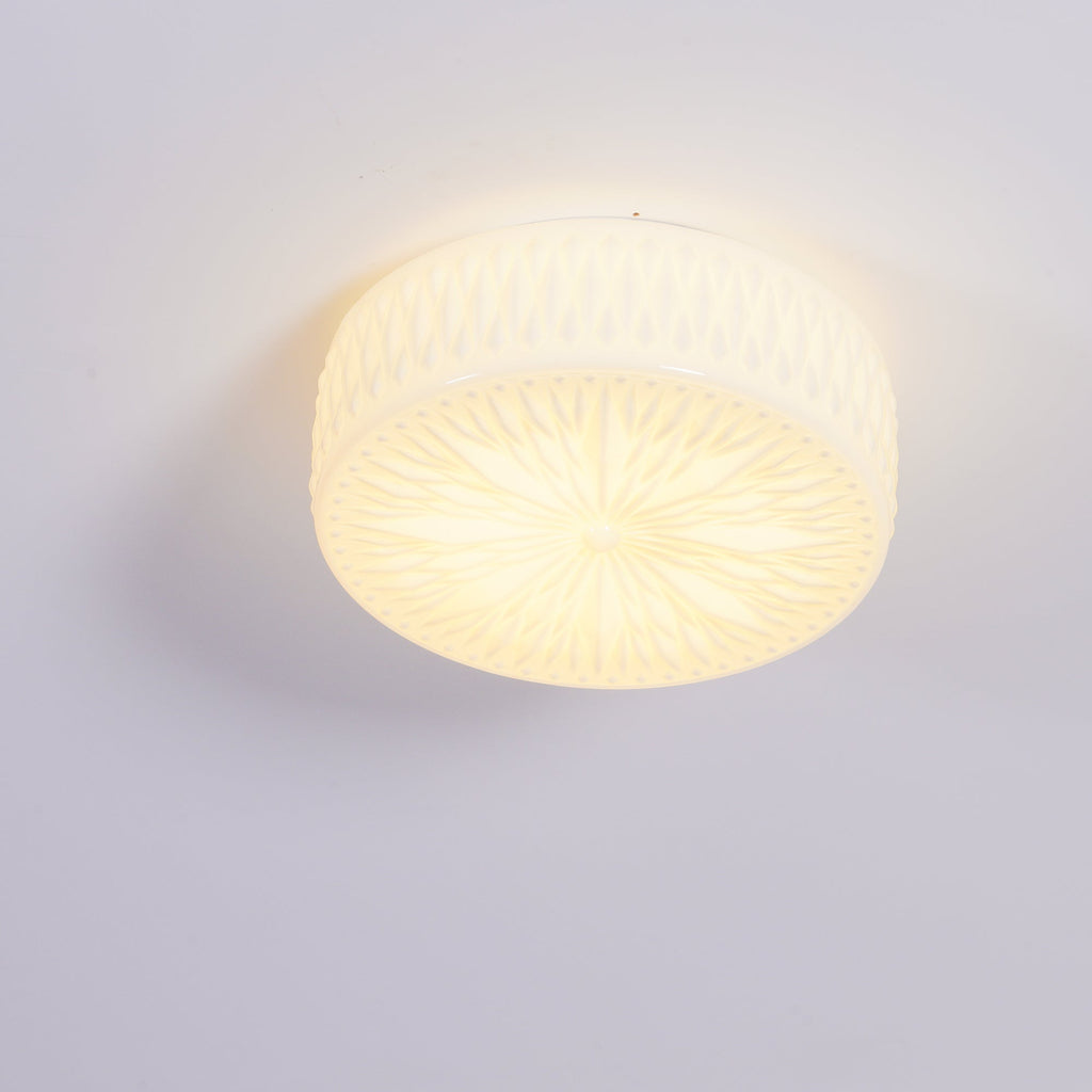 Adler ceiling light shown lit above a seating area