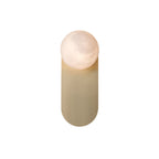 Adela alabaster wall sconce on a white background, round stone shade set against its brass pill backplate